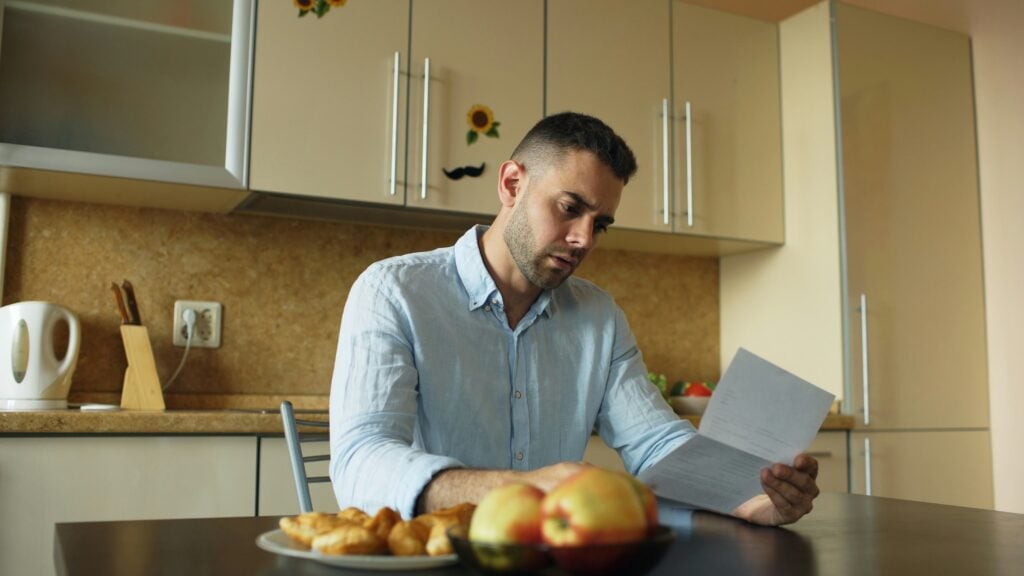 man looking at paperwork 8 things to know about insurance rehab