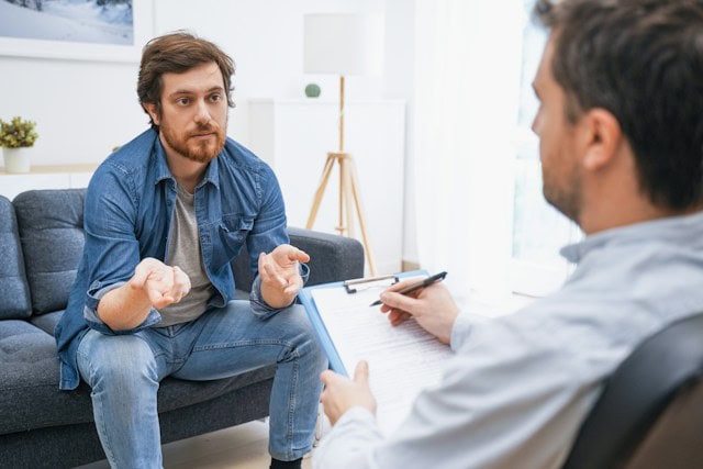 man talking to therapist residential vs outpatient rehab